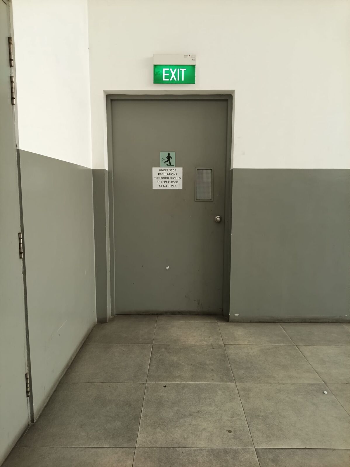 Before: solid grey steel exit door